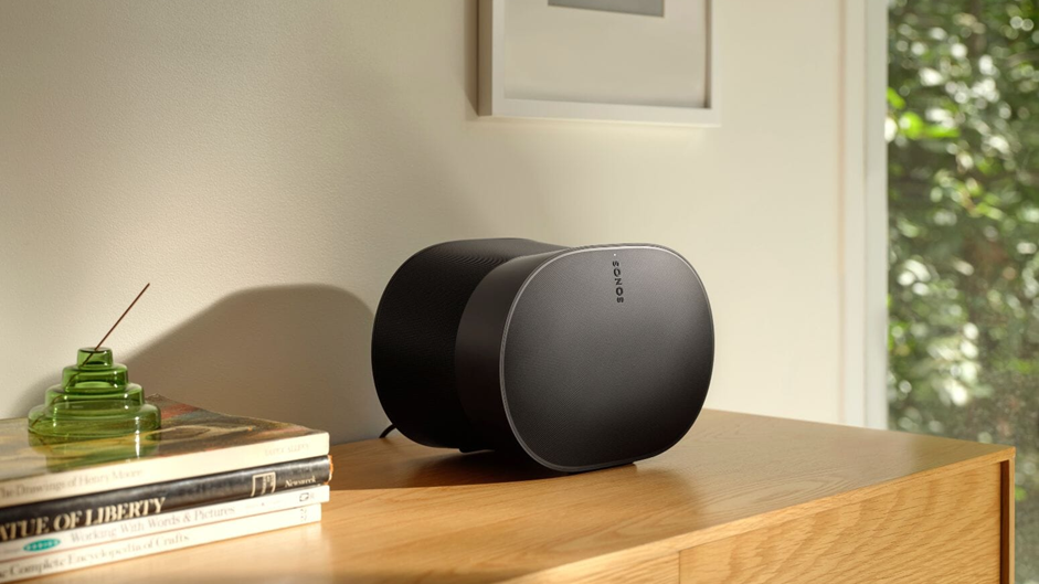 An image of a Sonos Era 300 in black sitting on a cabinet