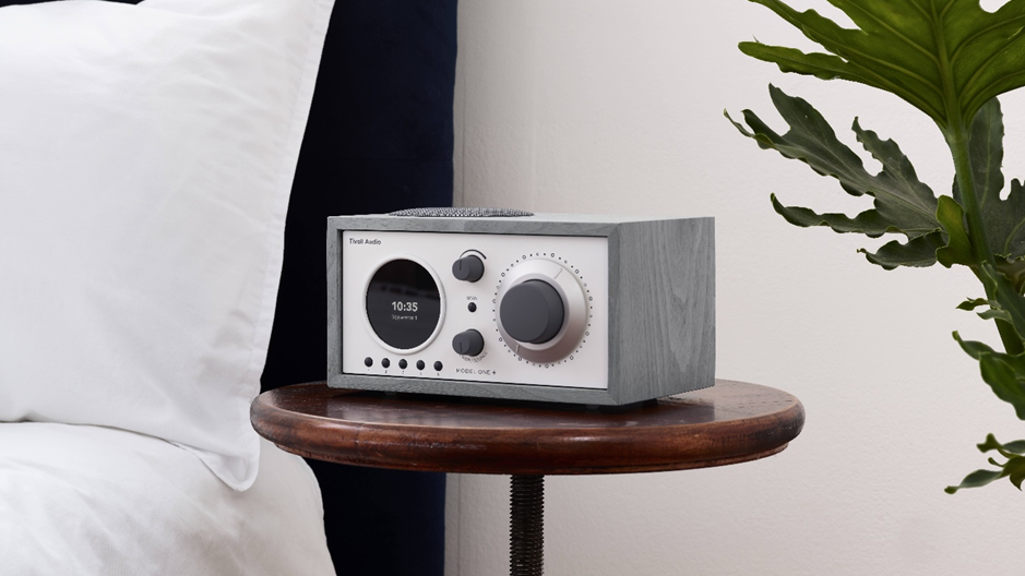 An image of a Tivoli Model One + in Grey on a bedside table