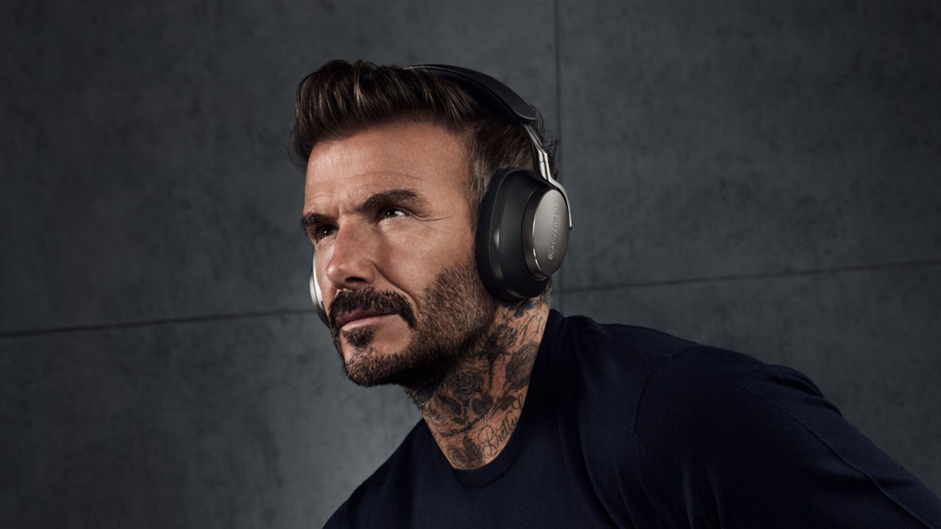 An image of David Beckham wearing Bowers & Wilkins PX8 headphones.