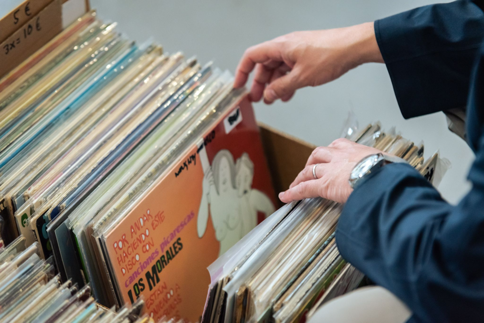 An image of someone looking through a box of vinyl.