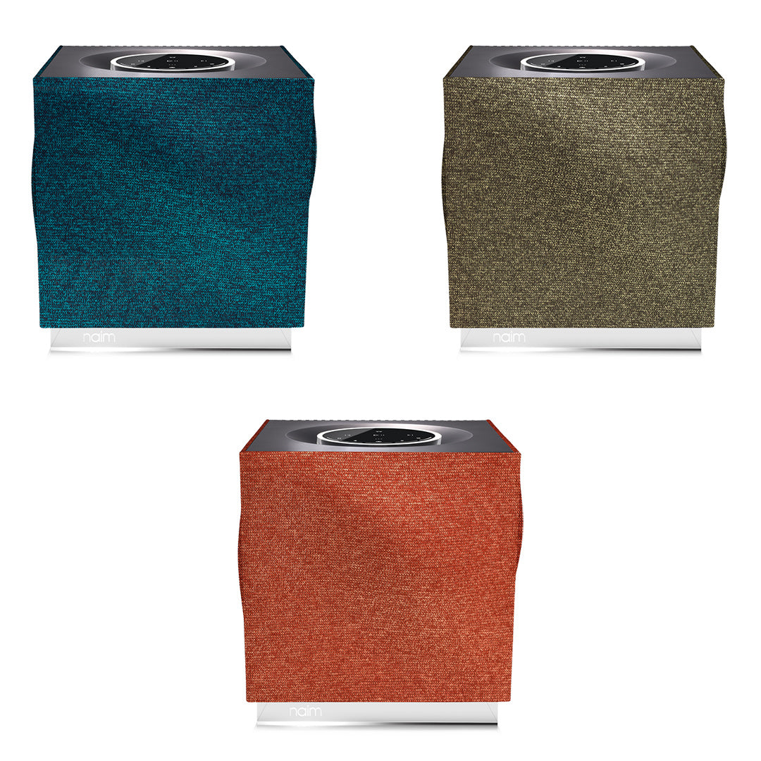 Image of the 3 options of Naim Mu-so Qb grille options. Peacock (top left), Olive (top right) and Terracotta (bottom middle).